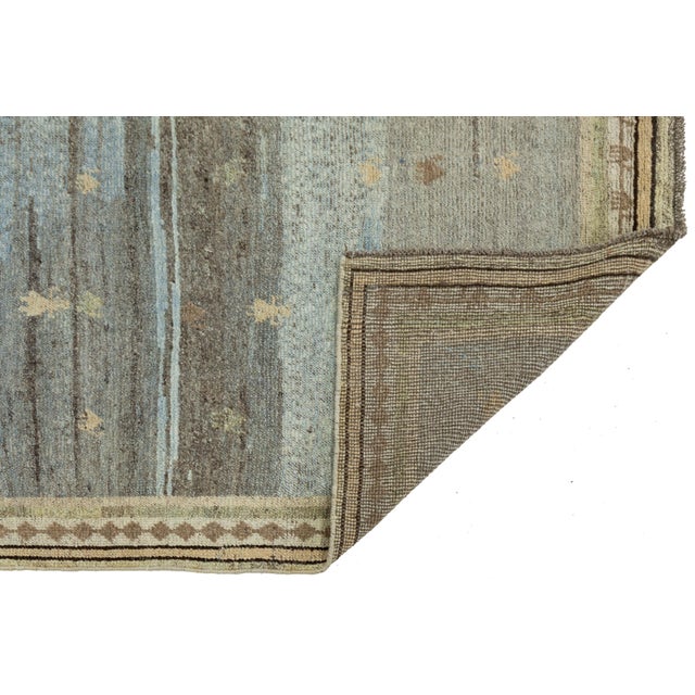 Transform your living space with this Hand-Knotted Gabbeh Wool Rug. Crafted by hand with premium, hand-spun wool, it...