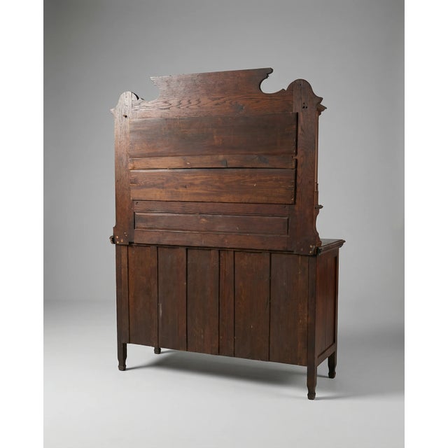 A beautifully crafted antique oak sideboard featuring a classic mirror-back design with turned columns and a shaped crown....