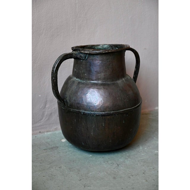 with its rich patina and striking luster, this large water jar is a truly captivating piece. Made of copper and metal, it...