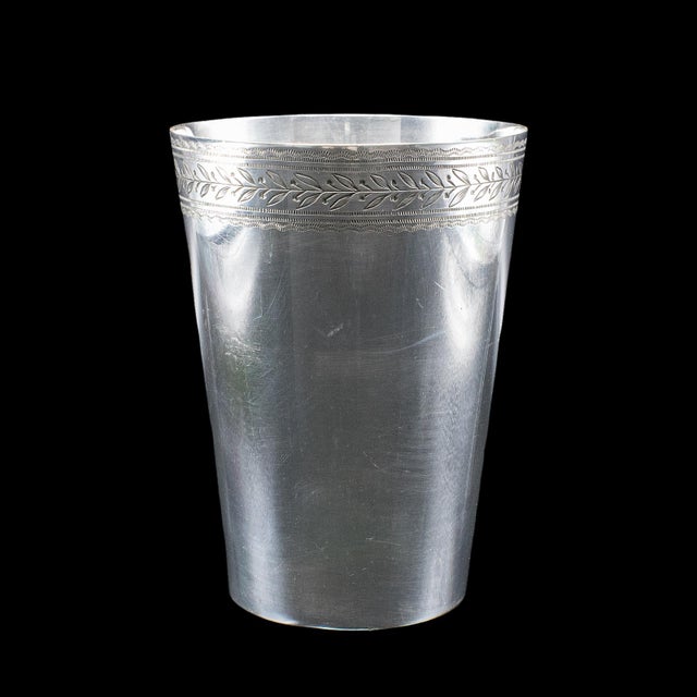 This is an antique explorer's beaker case. An English, silver plate and leather travel cup set, dating to the Edwardian...