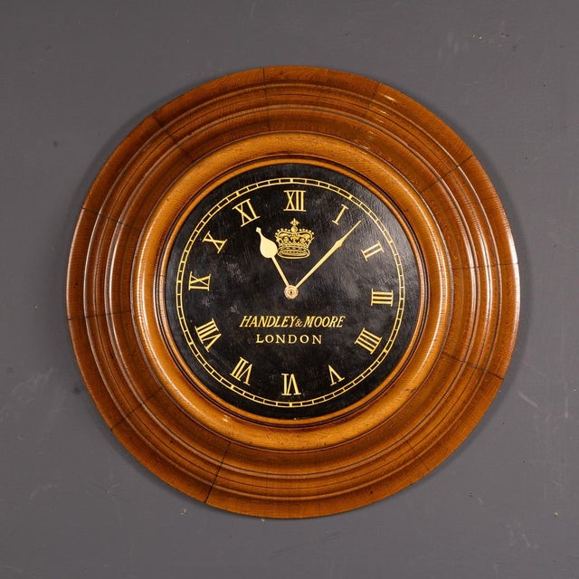 Antique 20th Century English llarge wall clock with a beautifully layered oak surround. The dial has been repainted and it...