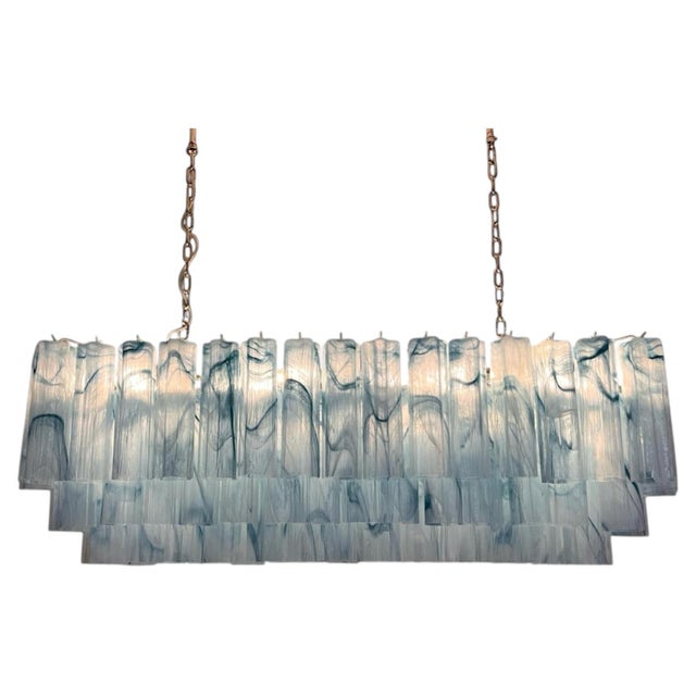 Spectacular Italian Mid-Century Modern chandelier in handblown blue Murano glass, featuring an impressive elongated...