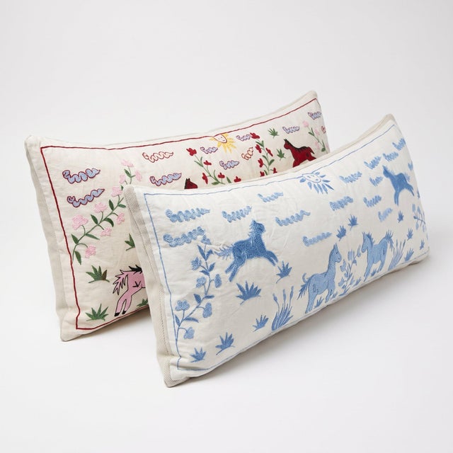An extra-long lumbar pillow cover set made from hand-embroidered Uzbek Suzani cotton — hand embroidered horses and sun on...