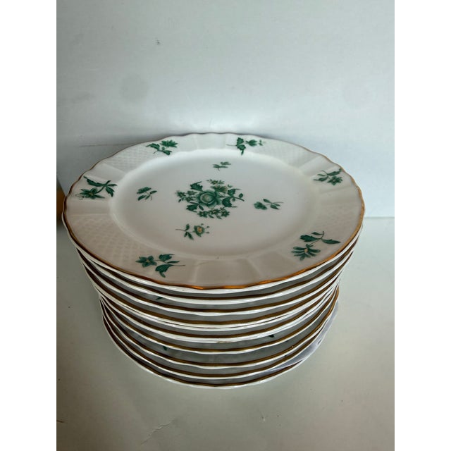 A refined set of 11 Limoges porcelain dessert plates, made in France by L. Bernardaud & Co. and retailed by the celebrated...