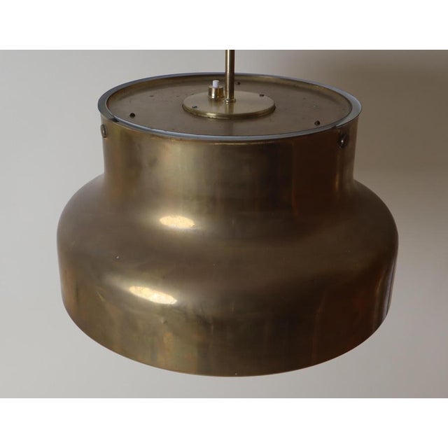 This lovely Swedish pendant lamp is a real gem, with its rich history and the beautiful natural patina of the brass. This...