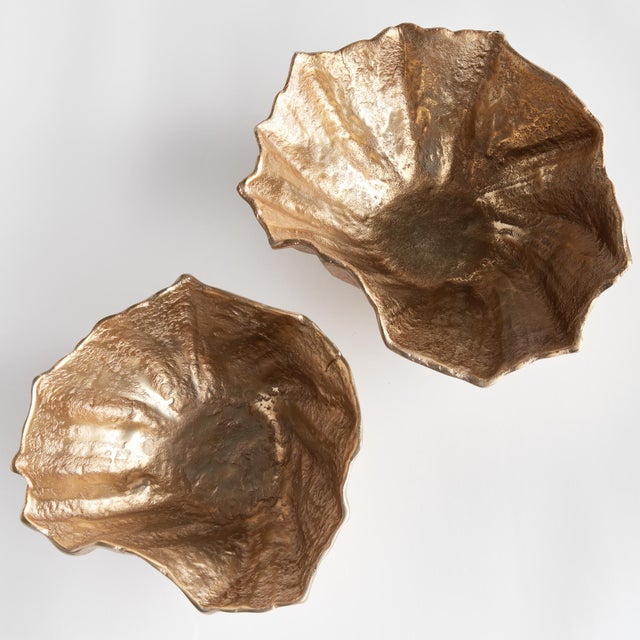Made of cast aluminum, these rounded bowls are fashioned to look like seashells. A coastalinspired set that can hold...