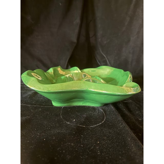 This vintage decorative glass bowl features a distinctive organic, wave-like ruffled edge reminiscent of Art Deco-era...