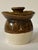 This is a handmade brown and cream colored honey jar pottery piece. It could be used as a candlestick holder or as a vase....