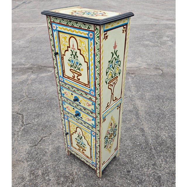Beautiful hand-painted storage cabinet Morocco, measuring approximately 49" in height, 18" in width, and 12" in depth....