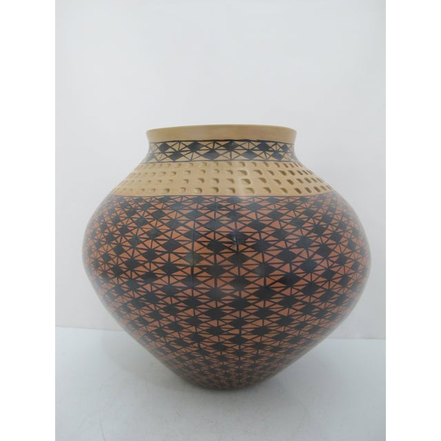 Mata Ortiz Mexican pottery, handcrafted and signed by the artist Amalia Mora. Large wide body and short neck vessel with...