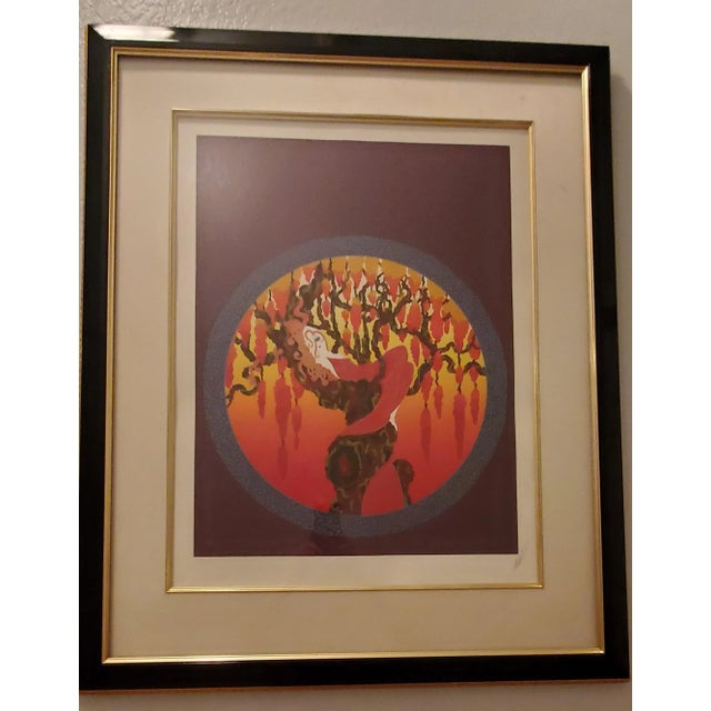 This piece by Erté is titled Heat. Which depicts an elegant woman lying atop a grapevine, surrounded by grapes. A...