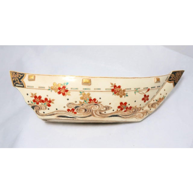 Japanese Satsuma Boat, Meiji Period, painted on the exterior with red flower heads floating above rolling waves. Country...