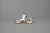 Decorative set of two glazed ceramic duck figures, consisting of one larger and one smaller piece. The ducks feature warm...