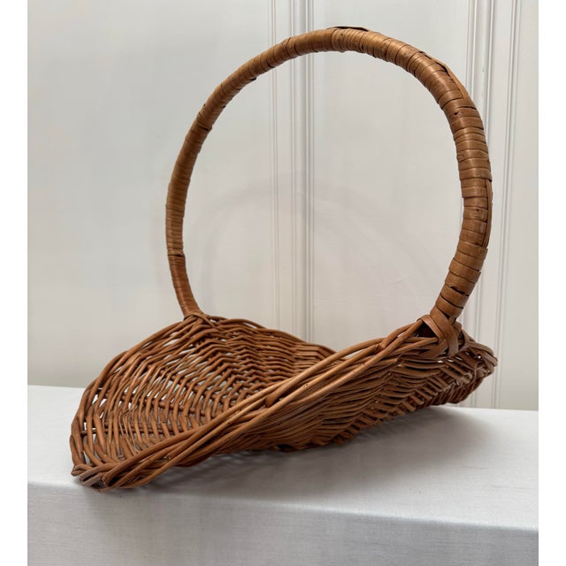 A monumental and substantial in size is this French Country inspired gathering basket. Comprised of woven wicker in warm...
