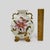 This fine antique Rudolstadt porcelain vase features a flattened round moon-flask body with elegant dual scroll handles...