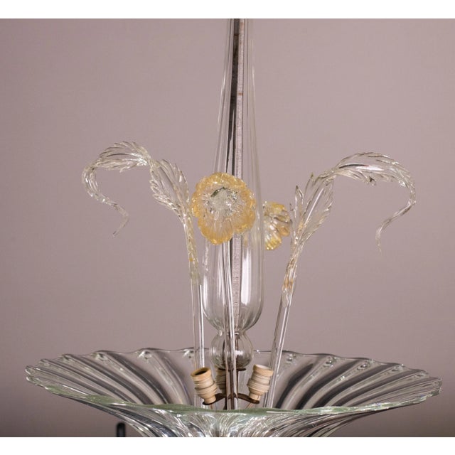 Gorgeous 1950s deco-era chandelier made of murano glass. the chandelier consists of a glass disc from which 2 leaves and...
