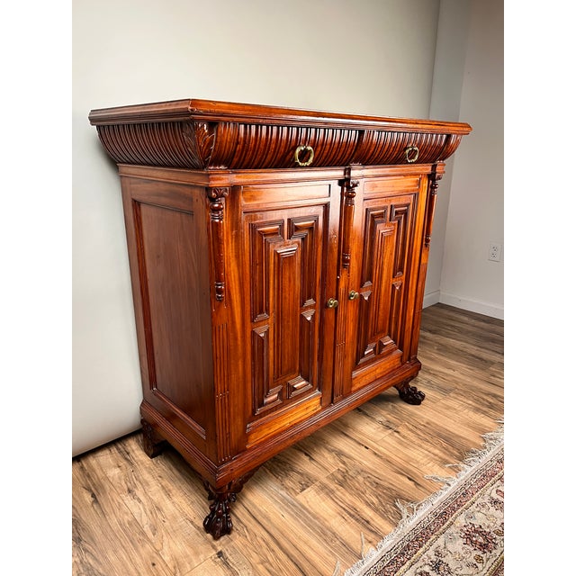 This handsome English Jacobean Revival buffet dates to the early 20th century and reflects the enduring popularity of the...