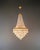 An elegant and compact crystal chandelier in a classic basket form. The chandelier features a clean, upward tapering...