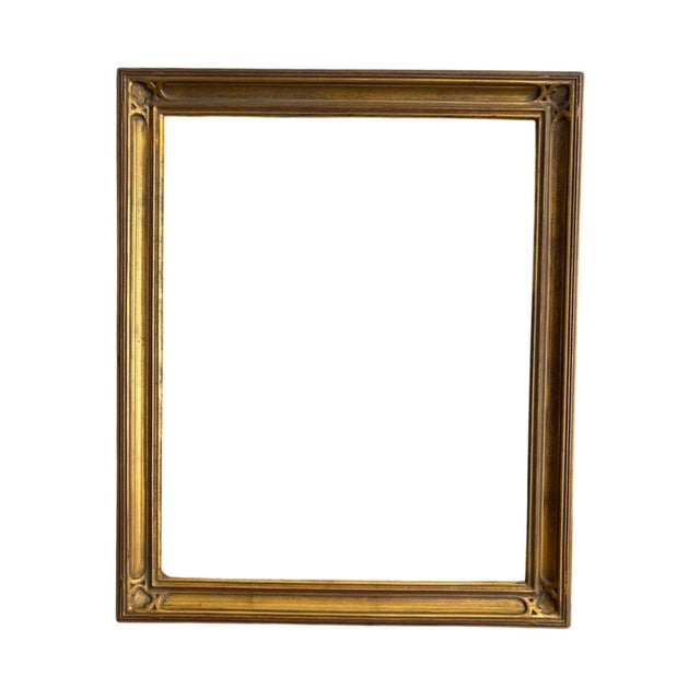 Vintage Arts & Crafts-style giltwood picture frame featuring clean architectural lines accented by quatrefoil corner...