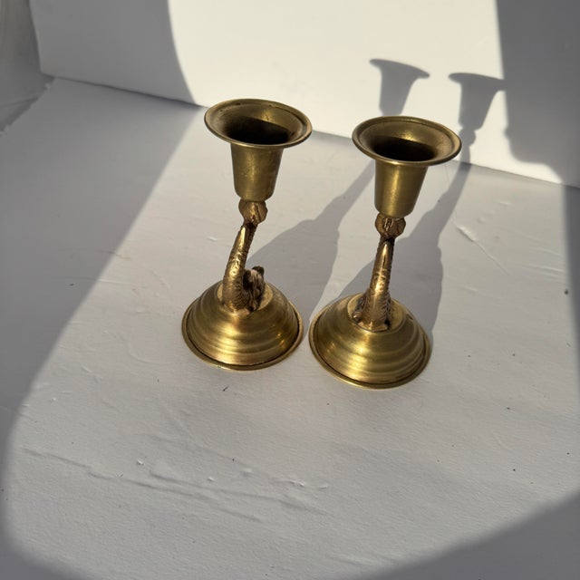 A pair of brass candlestick holders with a dolphin base. In good condition. Recently polished and lacquer coated so the...