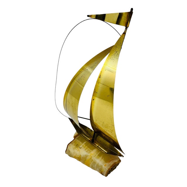 This beautifully preserved, vintage 1970s mid-century modern brutalist tabletop sculpture features a polished brass yacht...