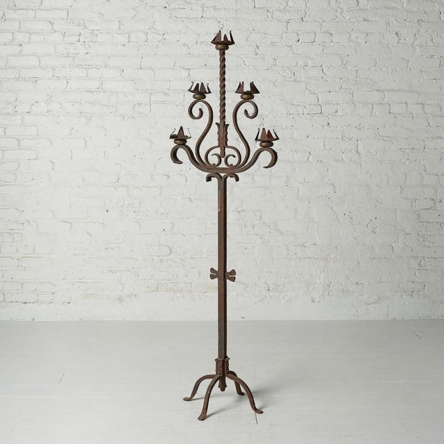 This Belgian iron candelabra, dating from the 1920s–1940s, features a sculptural form, aged patina, and timeless European...