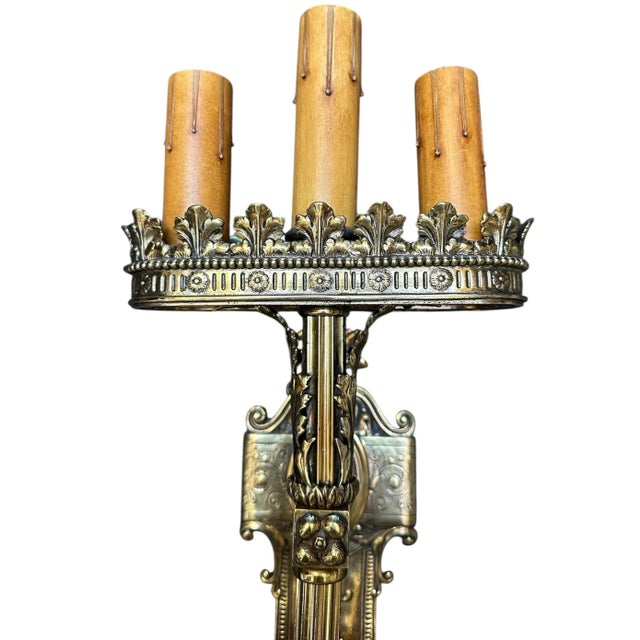 A rare pair! These solid brass wall sconces feature acanthus leaves and a crown like pattern with small floral details....