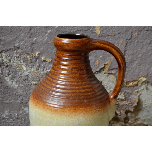 with its beautiful dimensions and its textured and mineral enameling, this pitcher vase signed Bay Keramik from the 60s is...