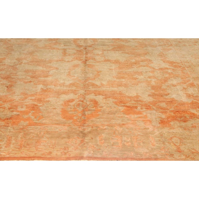 This exquisite antique Turkish Oushak rug, dating to the 1920s, is a quintessential example of Anatolian...