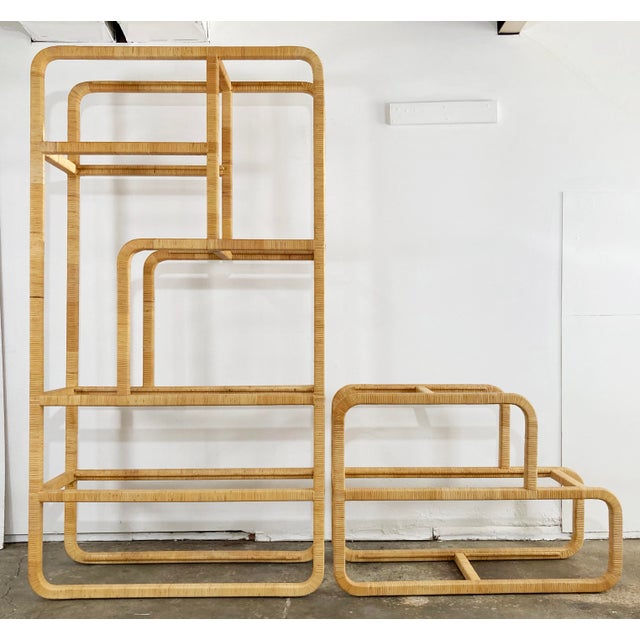Vintage mid-century modern rattan wrapped etagere / shelving unit. Taller unit features six glass shelves of varying...