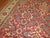 Room size Persian antique Mahal room size rug featuring an all-over repetitive design on a red field and beige/ivory...