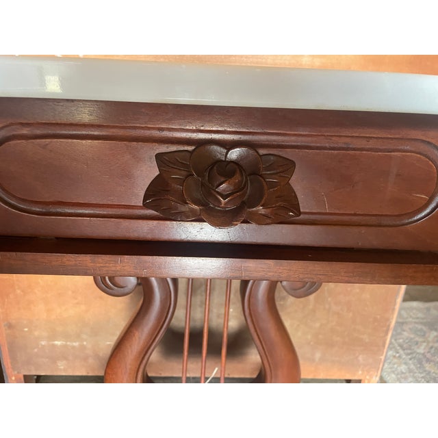 A classic marble top mahogany side or end table with on a lyre central stand. This one drawer table features a marble top...