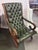 An English Regency Green Tufted Leather Lolling or Lounge Chair with brass tack trim, circa 1820-40, the mahogany frame...