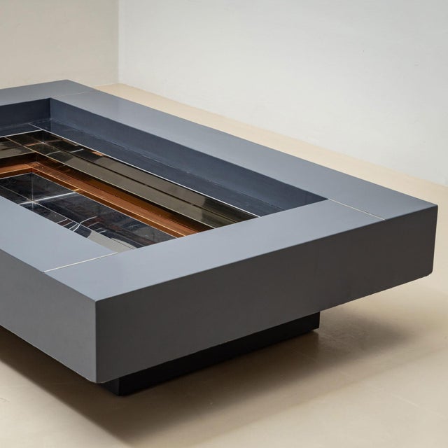 An elegant coffee table designed by Alain Delon (French, 1935–2024) for the renowned Parisian furniture house Maison...