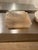 The Kros Tray by Michael Verheyden in Alabaster Tabac is carved from solid stone, showcasing warm, translucent tones and...