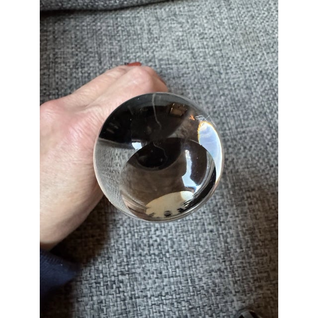 One figure is rendered in rich, vibrant scarlet red glass, symbolizing fiery passion, while the other is in deep onyx...