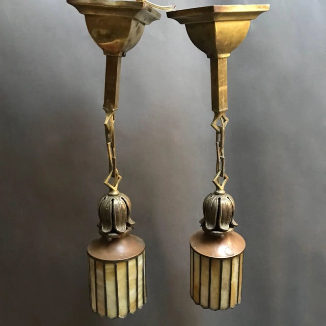 Pair of exceptional Arts & Crafts pendant lights circa 1920's feature shades with amber toned, stain glass panels housed...