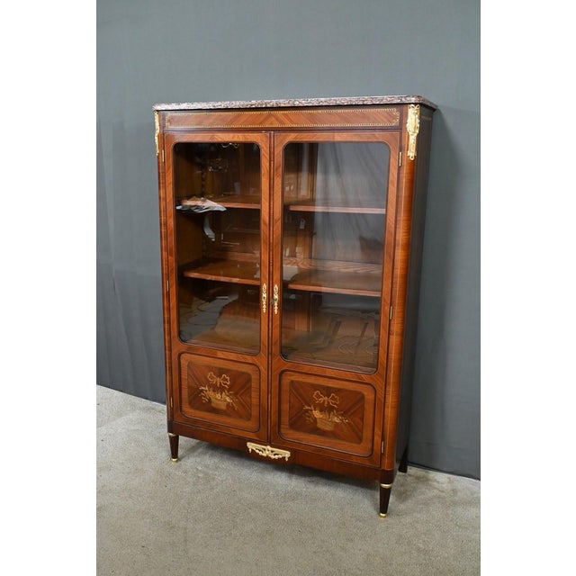 Elegance and finesse characterize this remarkable Louis XVI-style bookcase, a testament to the craftsmanship of the early...