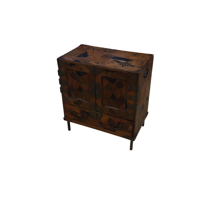 Beautiful raised small Japanese cabinet made during the Meiji period. Outside surface of the cabinet is decorated in...