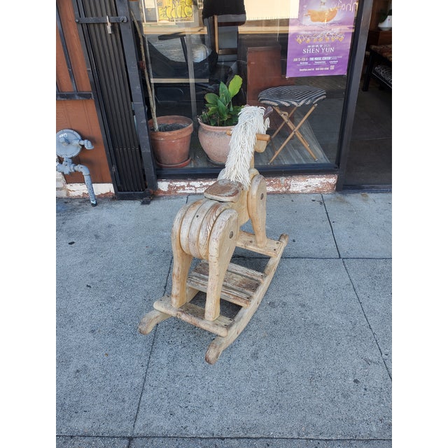 Very old shabby chic, solid wood horse. The horse shows lots of character and could really become a great conversational...