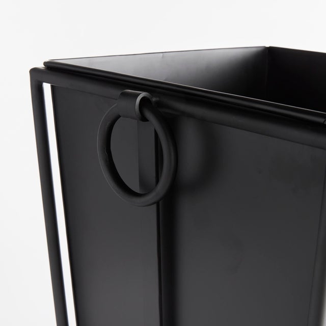 With metal liners that easily slide out, this sleek black outdoor planter is as practical as it is handsome. The rounded...