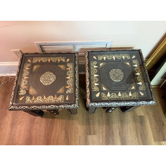 Unique find! Moroccan glass top tables showcase gilt painted tin, camel bone, and carved wood detailing. One in cream and...