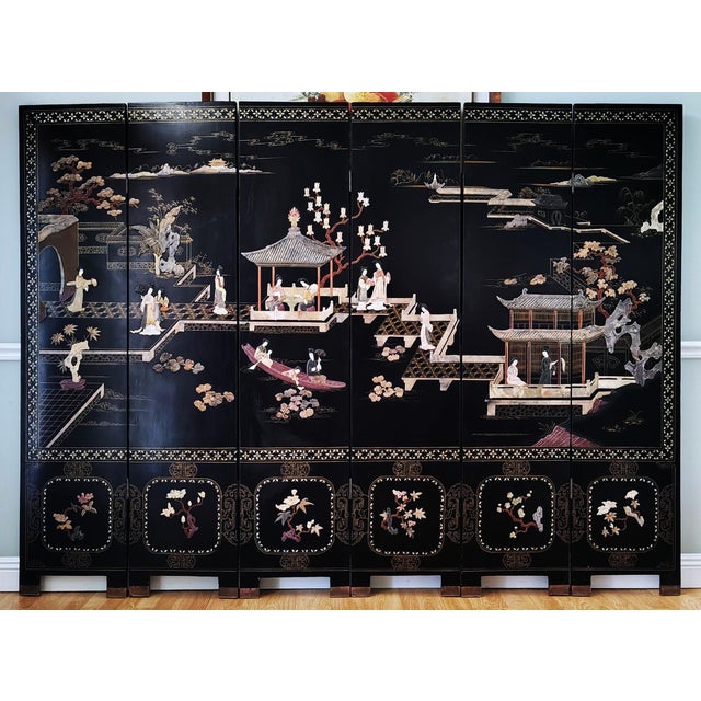 This beautiful Chinese export six panel lacquered coromandel screen features hand-carved soapstone of ladies in leisure...