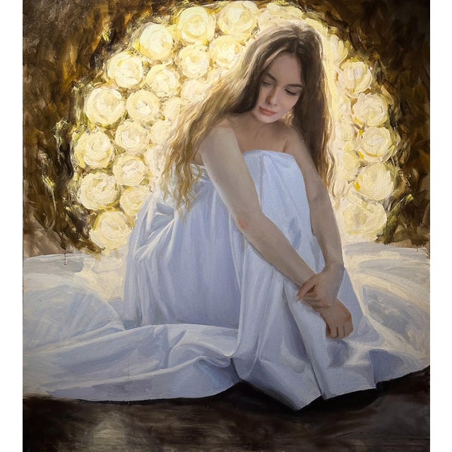 The artwork depicts a serene figure draped in a flowing white garment, seated against a luminous backdrop of soft, golden...