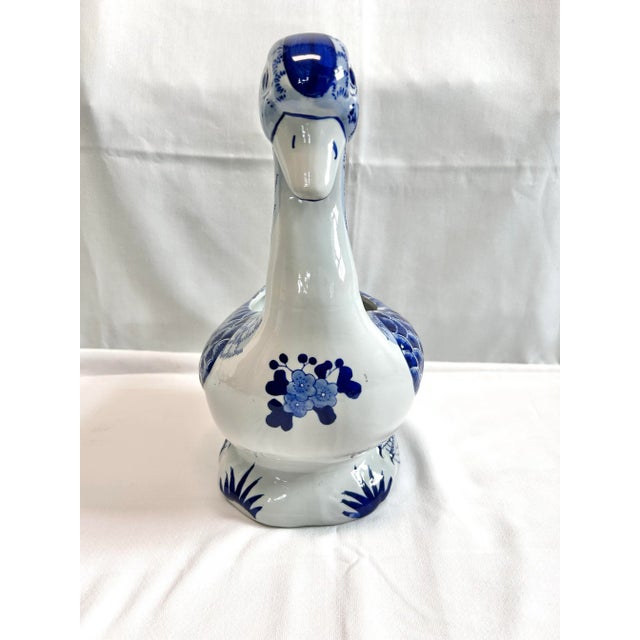 This blue and white ceramic duck cachepot is a whimsical vintage planter that blends chinoiserie style with sculptural...