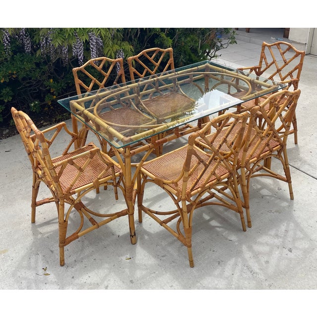 Gorgeous vintage rattan dining chairs attributed to Italian designer Dal Vera. Featuring chippendale styling fretwork and...