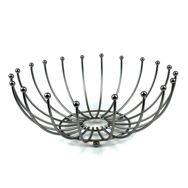 This basket is so unique. We are obsessed with the cool lines and dramatically curvy design. Strong enough to hold many...