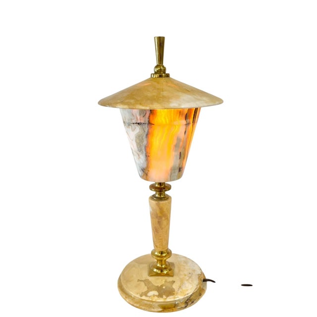Elegant vintage French table lamp from the 1960s featuring richly veined marble paired with warm brass accents in the...