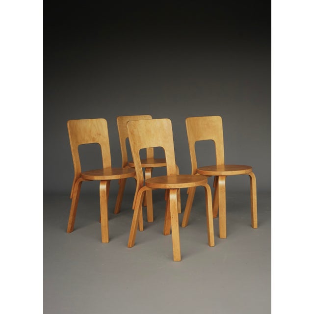 A rare set of four model 66 dining chairs designed by Alvar Aalto in the late 1930s. Two if the chairs have early light...