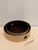 Elegant set of two nesting round trays wrapped in taupe faux crocodile embossed leather with rich chocolate brown...